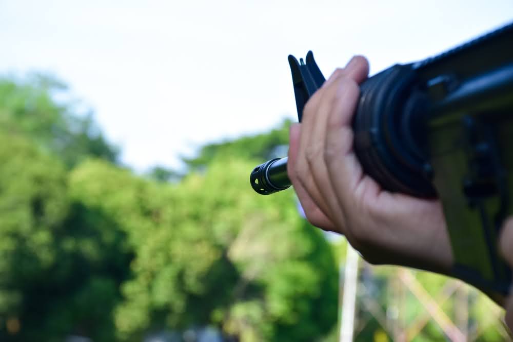 A man testing gas VS electric airsoft guns.